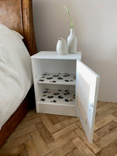 Load image into Gallery viewer, Pair of cane webbing panel bedside cabinets, lined with Black and white snow leopard!