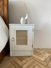 Load image into Gallery viewer, Pair of cane webbing panel bedside cabinets, lined with Black and white snow leopard!